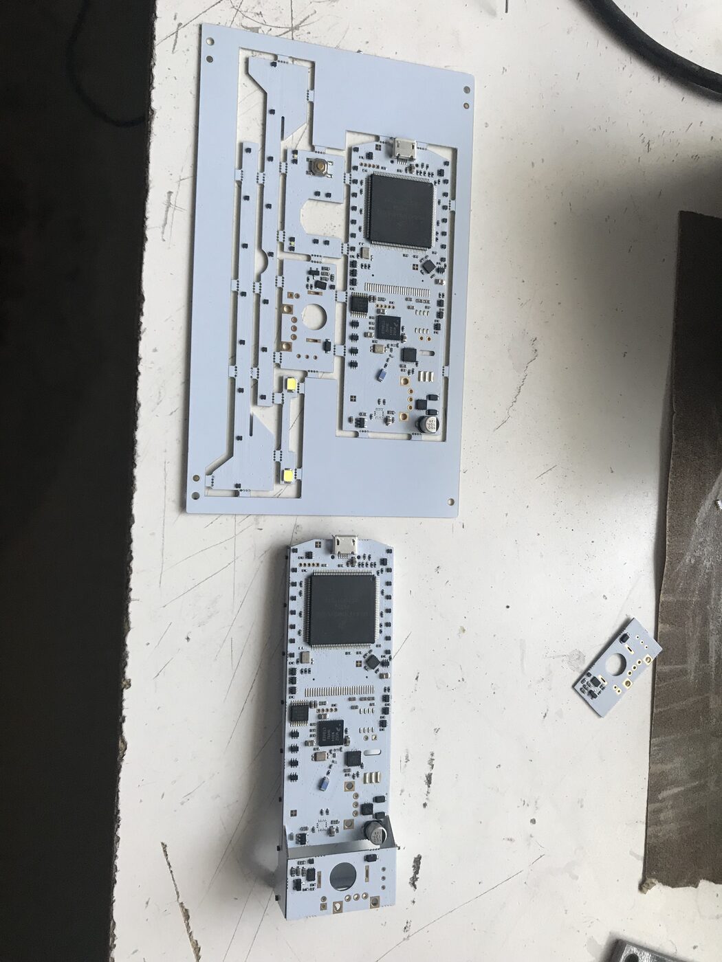 Bare and assembled badge circuit boards on a bench
