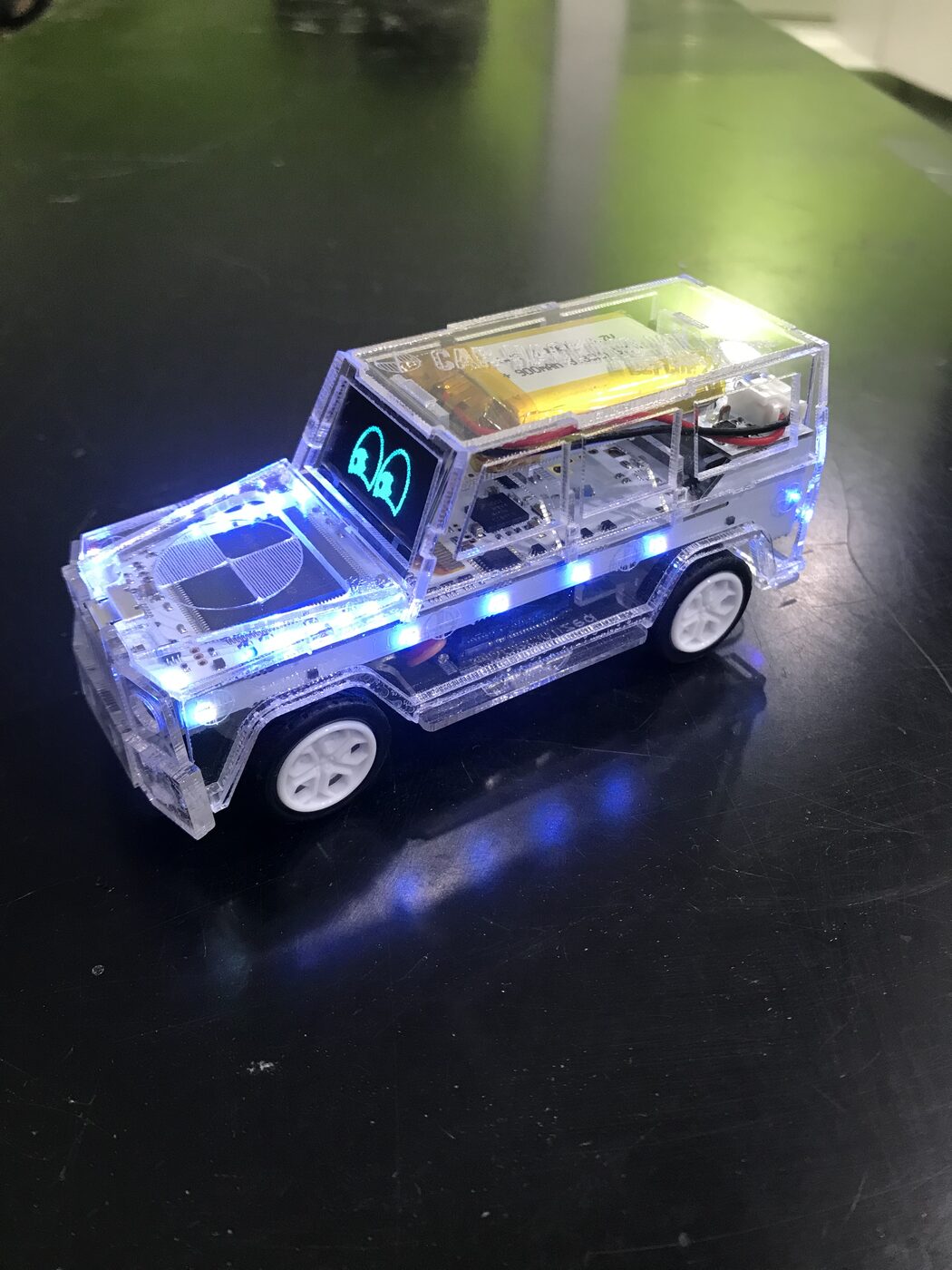 2019 DEF CON badge, a clear acrylic SUV lit in blue